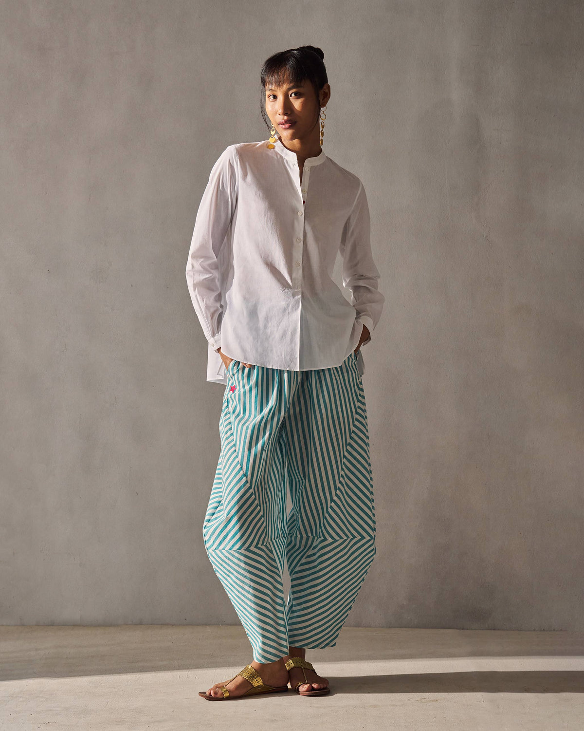Full-length view of the teal and ivory Breeze Pants with a gathered waist, worn by a person.