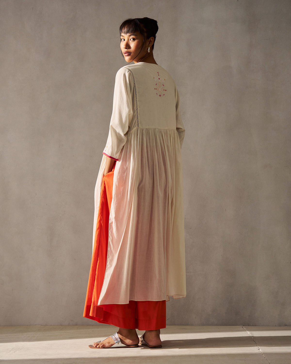 Back of an ivory Sara Gathered Kurta with a small embroidered motif at the yoke.
