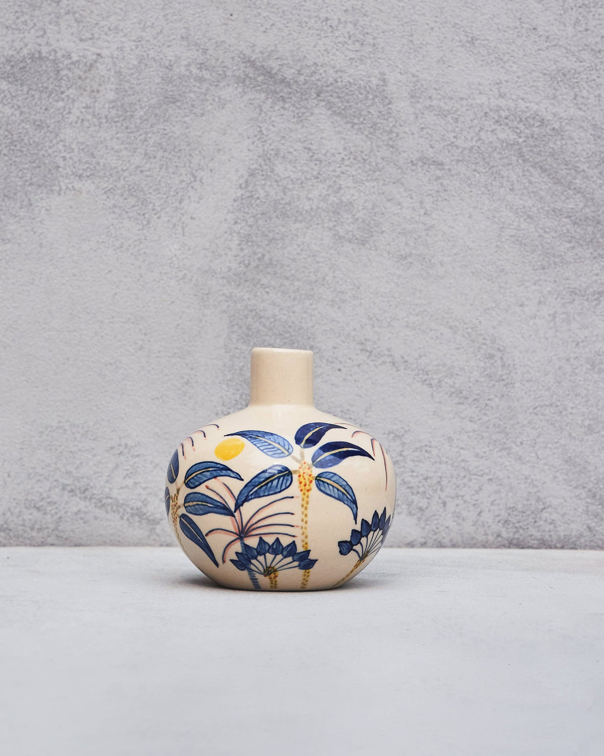 Palm Breeze Vase with blue palm leaves and a gold stripe, seen straight on.