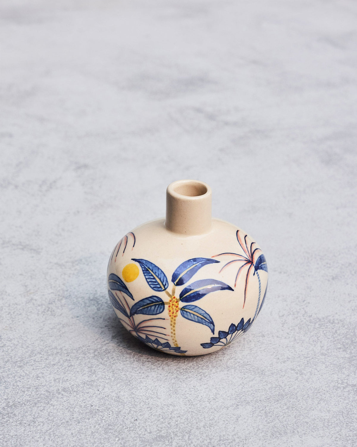 Angled view of the Palm Breeze Vase with blue palm leaves and a yellow dot.