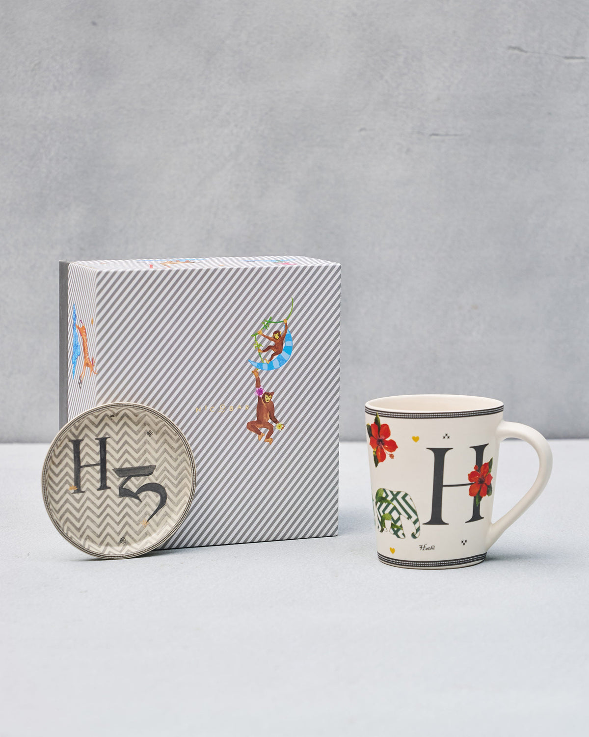 H Alphabet mug and coaster with letter H motifs beside a striped Nicobar gift box.