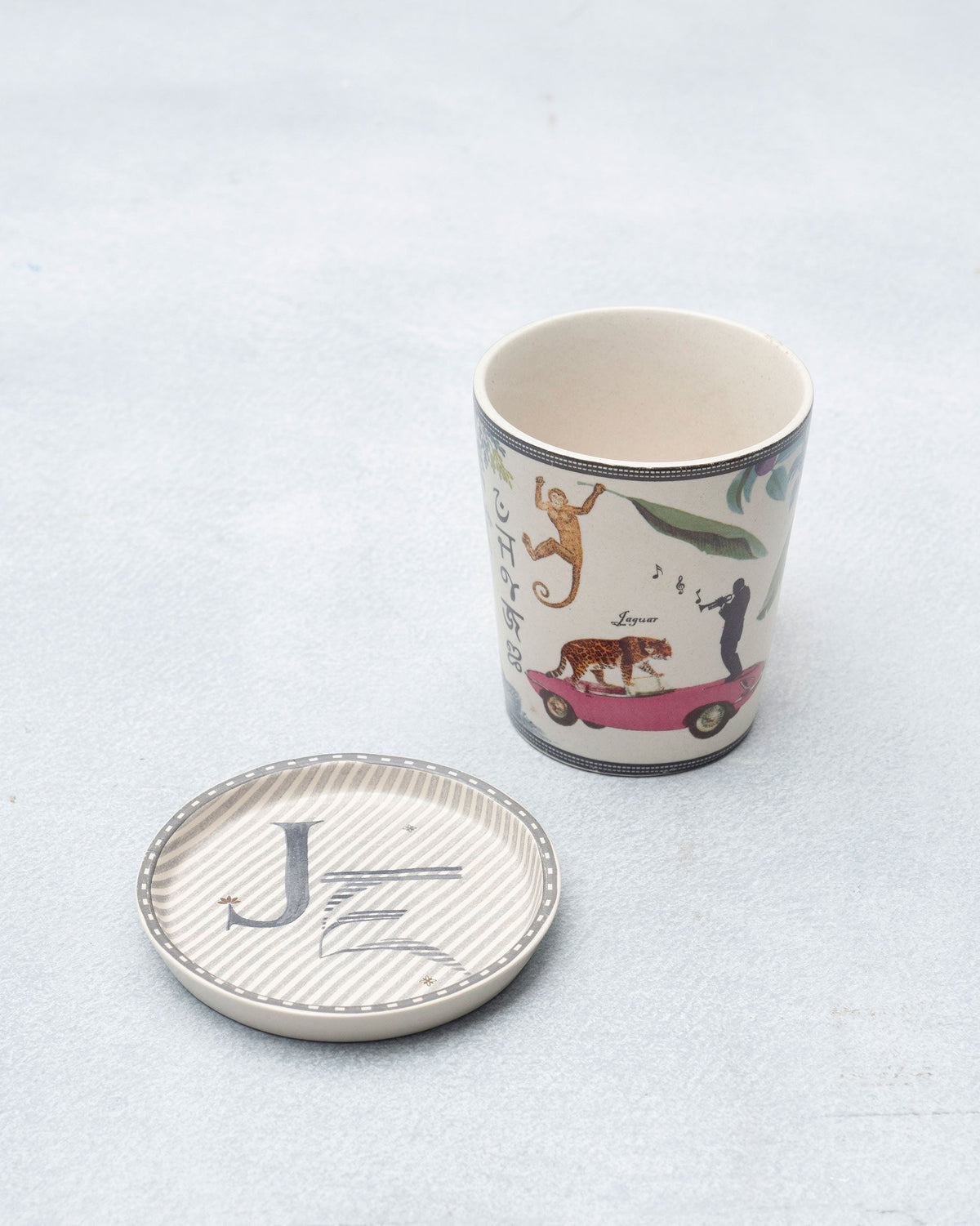 J Alphabet mug with jaguar and jungle motifs beside a letter J coaster.