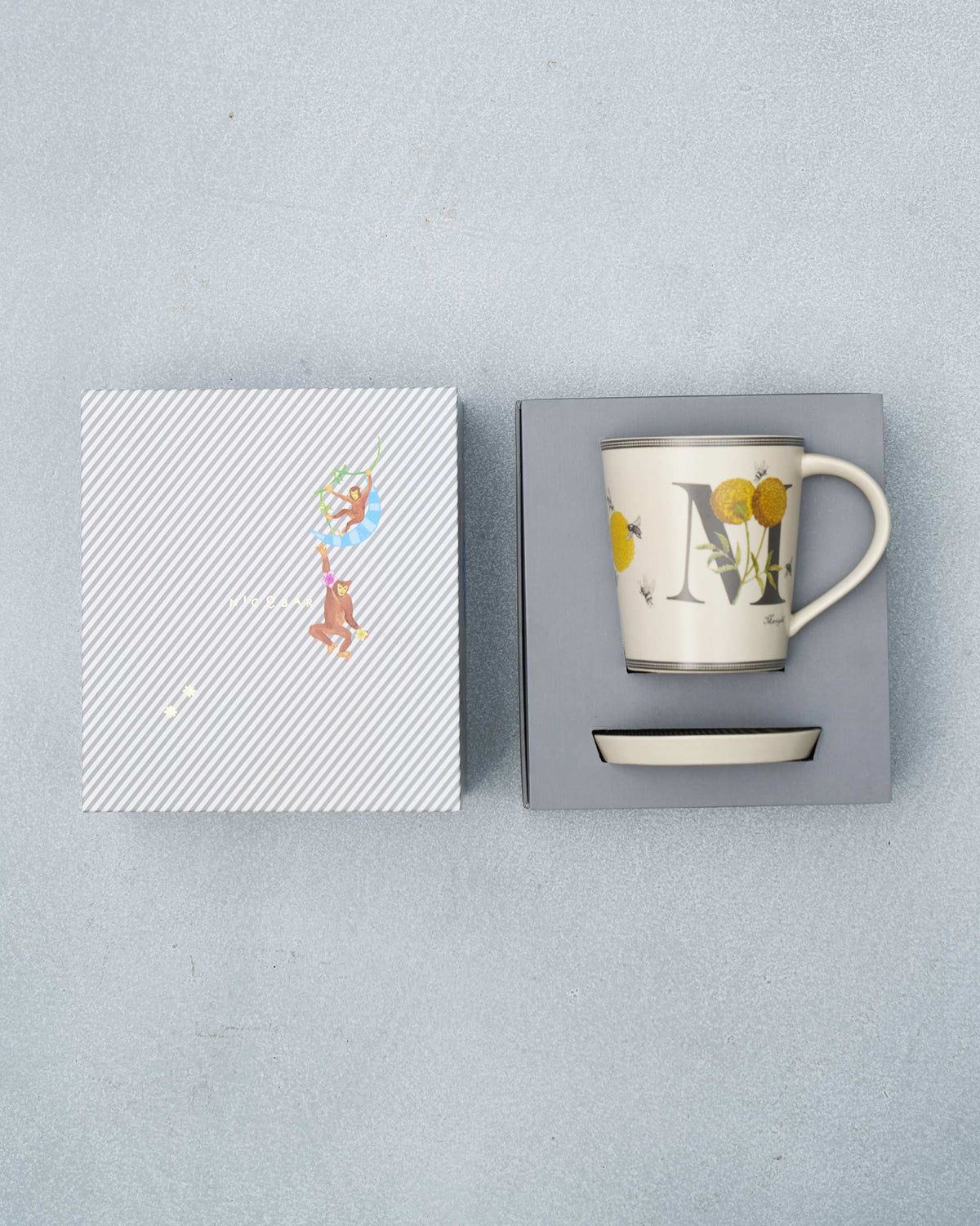 M alphabet mug and coaster packed in an open gift box.