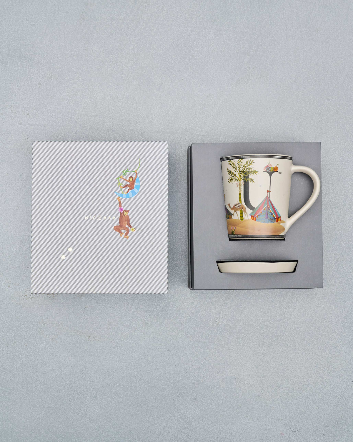 U alphabet mug and coaster packed in an open Nicobar gift box.