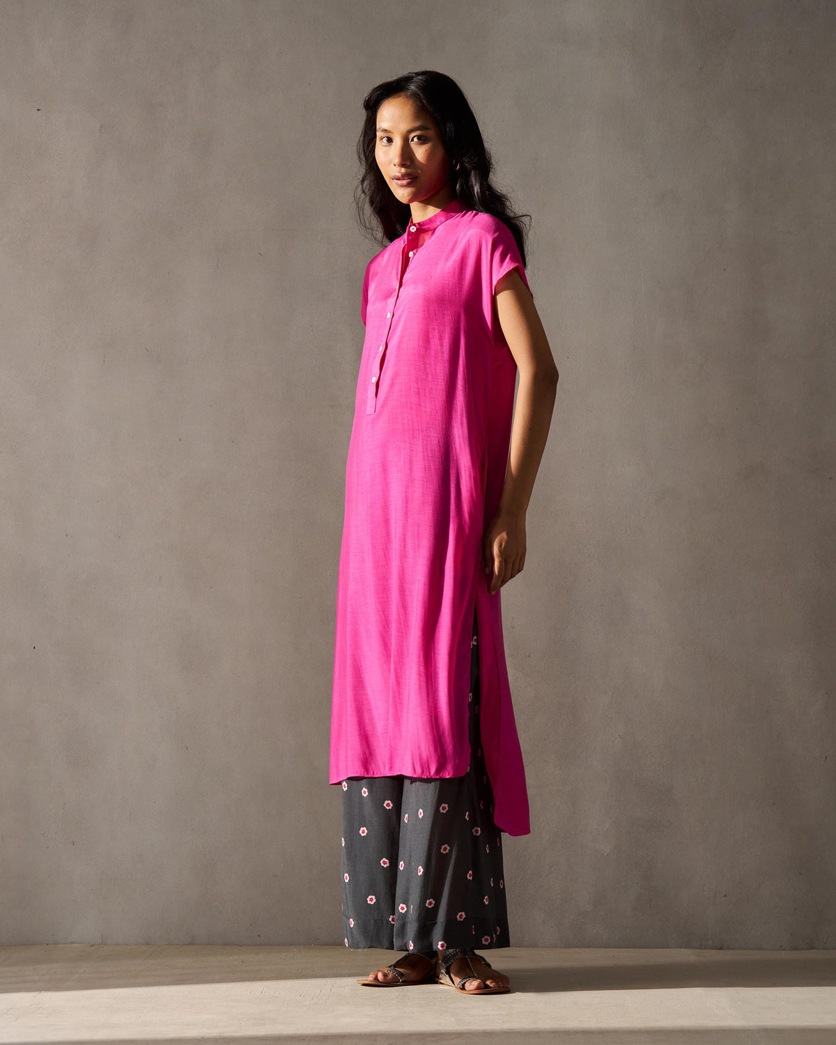 Side view of a magenta Short Sleeve Kurta with side slits worn by a person.