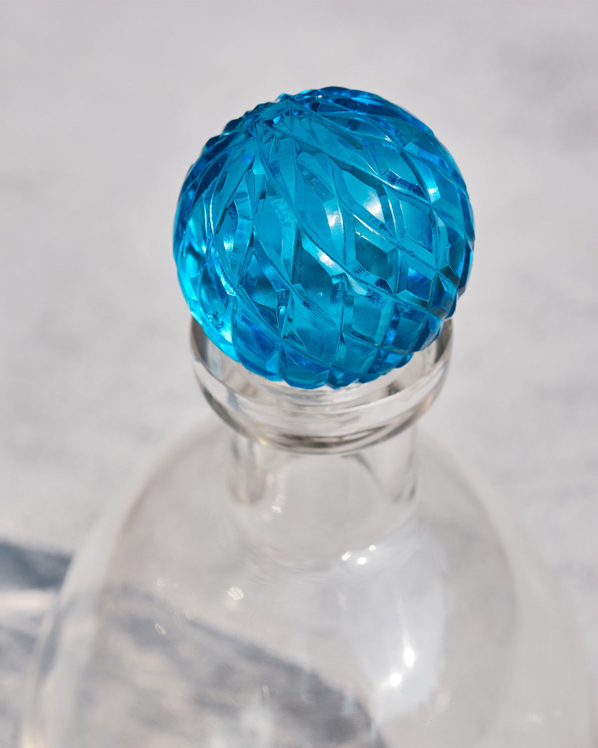 Close-up of the faceted blue stopper on a Revel Decanter.