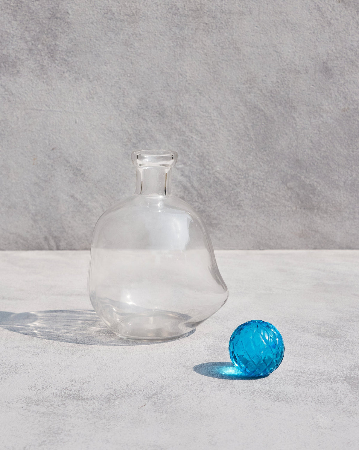 Revel Decanter with its blue faceted stopper set beside it.