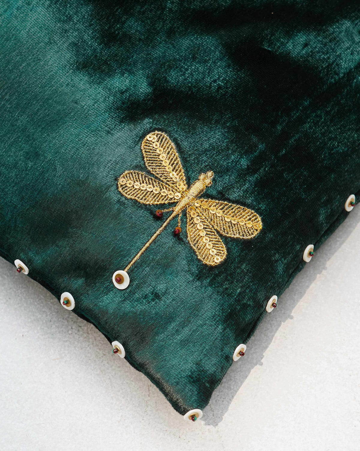 Close-up of the Tangier Tote showing a gold dragonfly embroidery and white-edged discs.