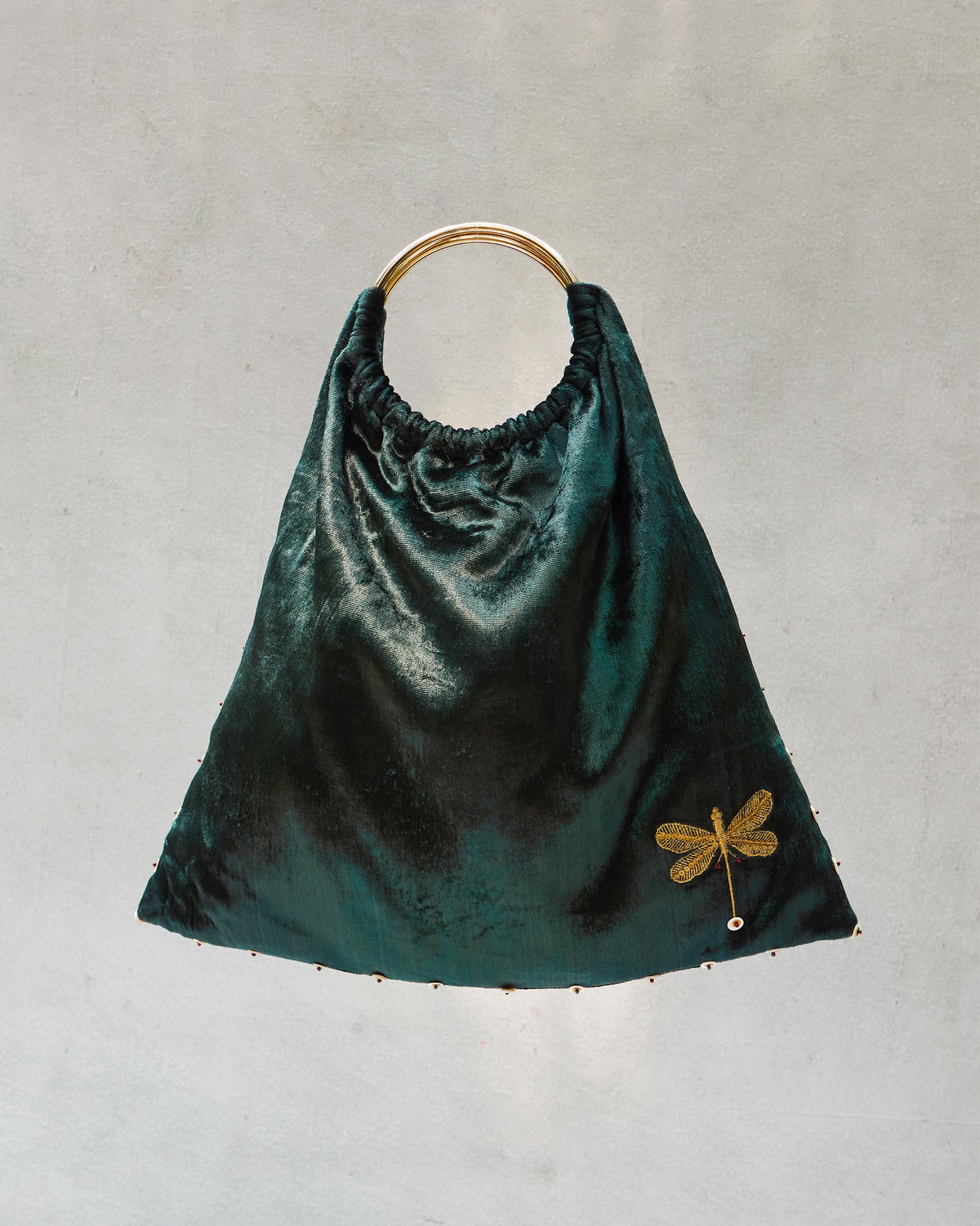 Tangier Tote with a gold ring handle and dragonfly embroidery.