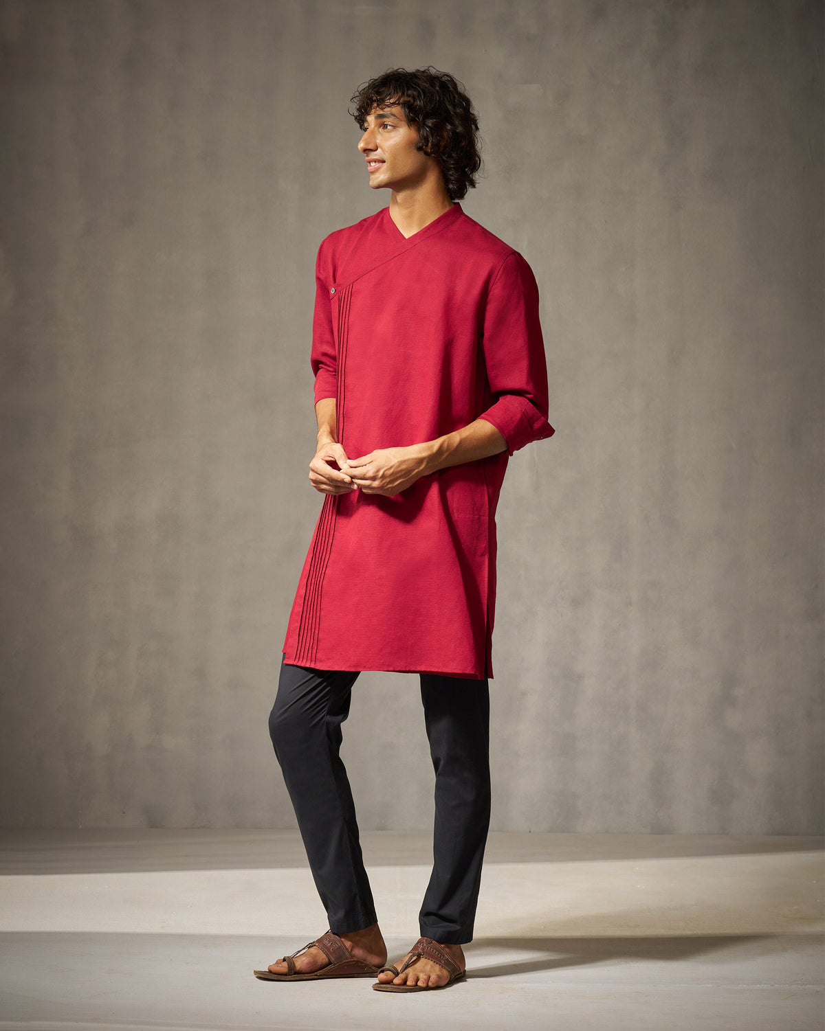 Three-quarter view of a red Staple kurta with a pleated wrap front worn by a person.