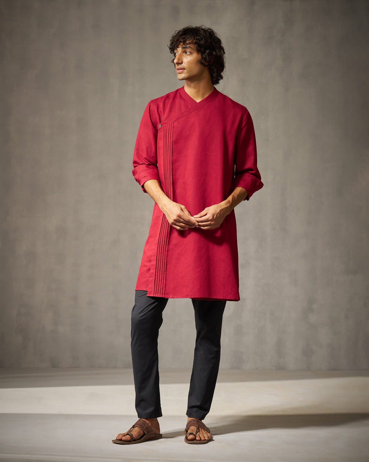 Front view of a red Staple kurta with a V neck worn by a person.