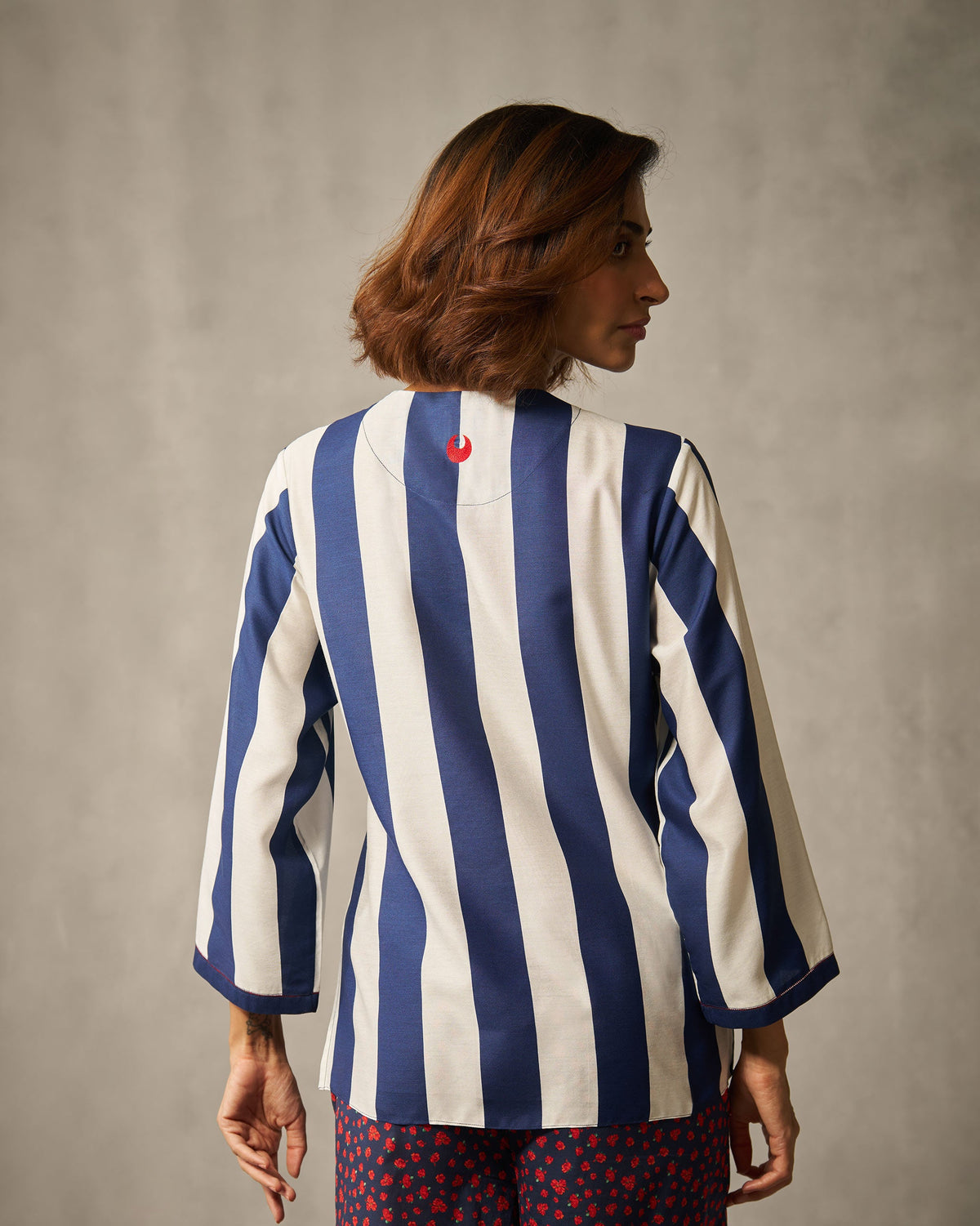 Back of a navy and ivory striped Fern wrap top worn by a person.