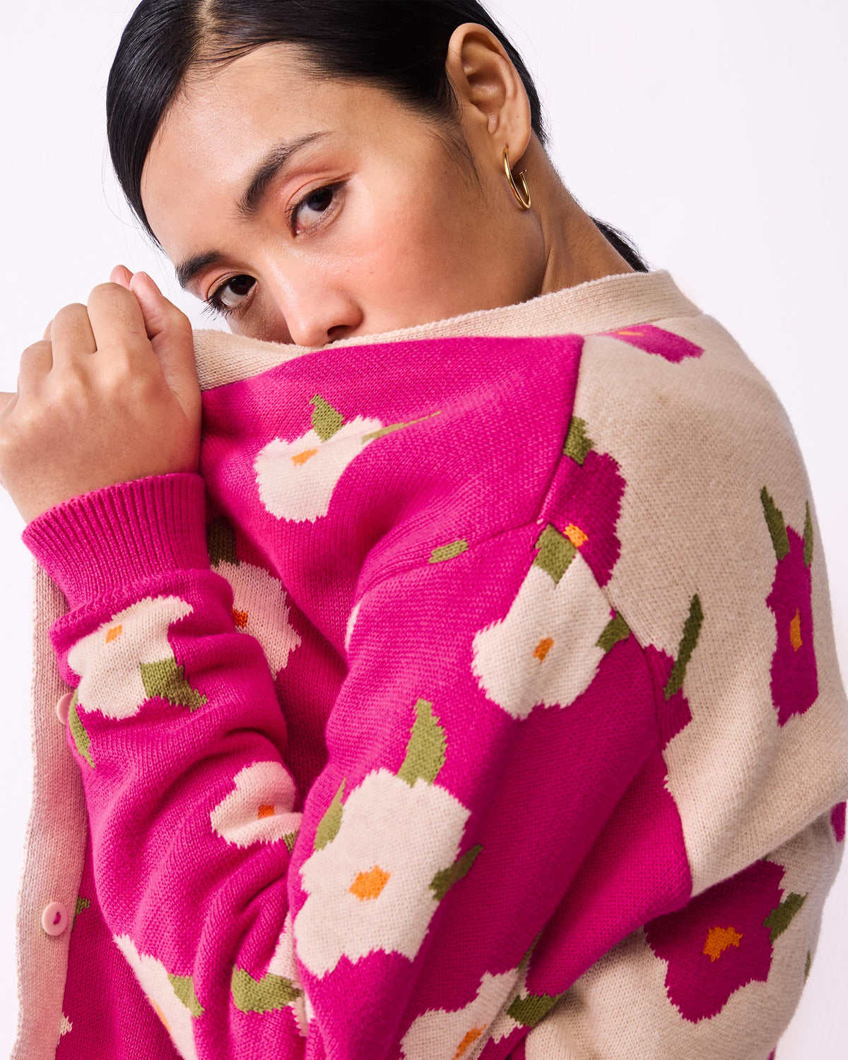 Close-up of Raven Cardigan sleeve showing a fuchsia and white floral knit.
