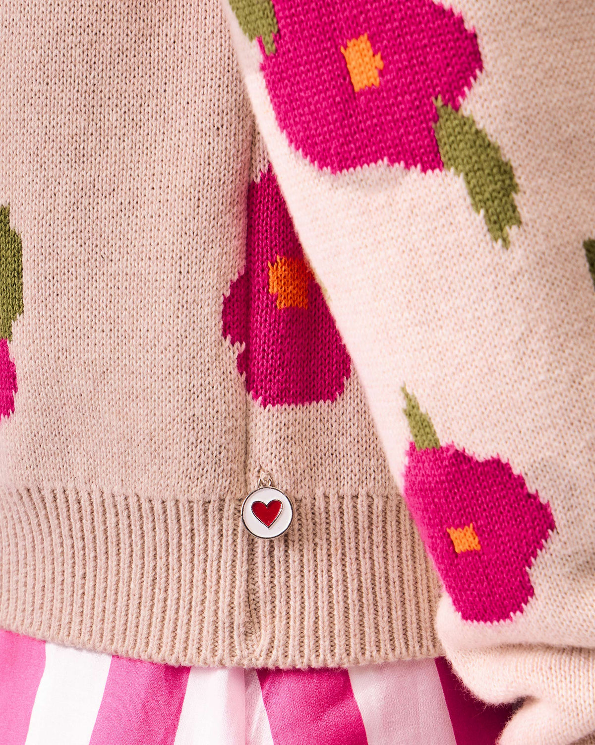 Close-up of Raven Cardigan hem with a red heart button.