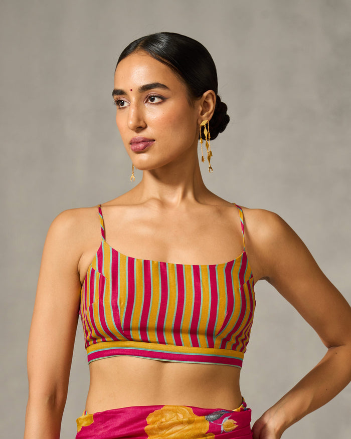 Person wearing a striped Strappy Blouse in yellow and pink.