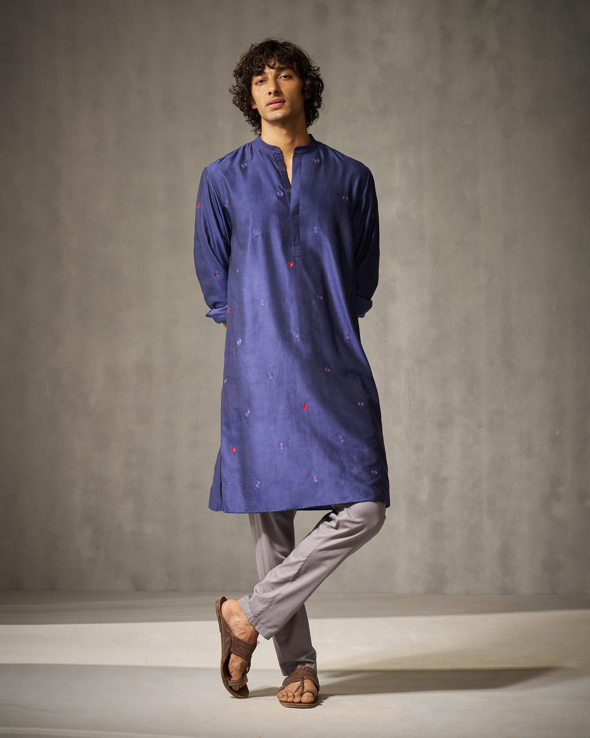 Person wearing a navy Neckband kurta with small embroidered blooms.
