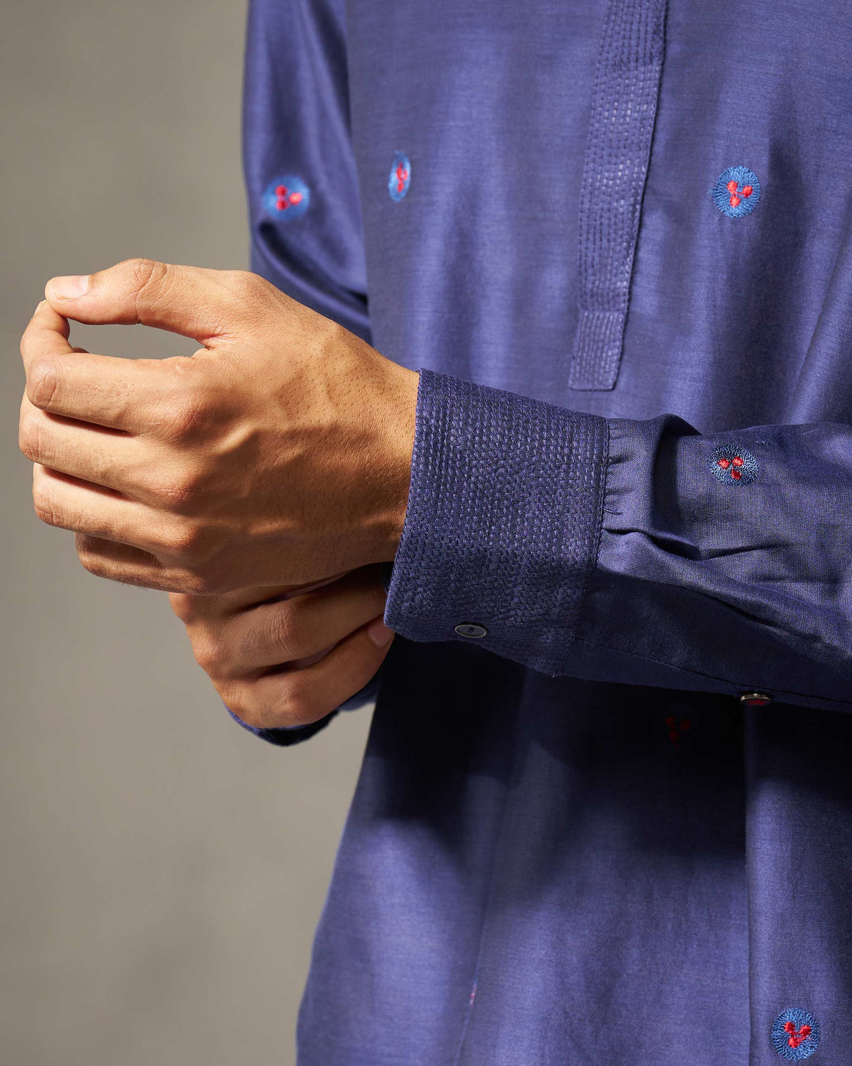 Close-up of a navy Neckband kurta cuff showing small embroidered blooms.
