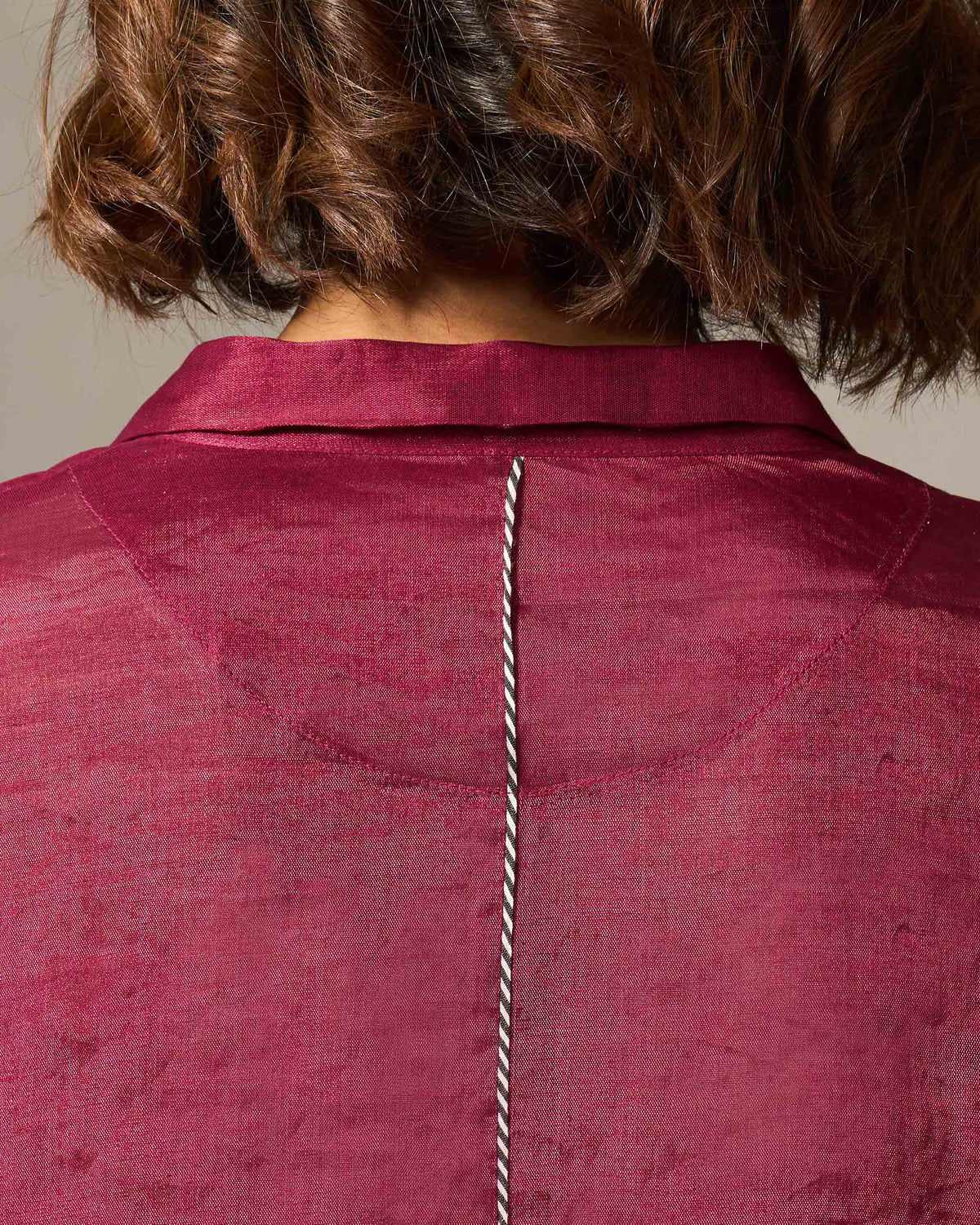 Close-up of the Treasure Kurta back neck with white cord piping down the back.