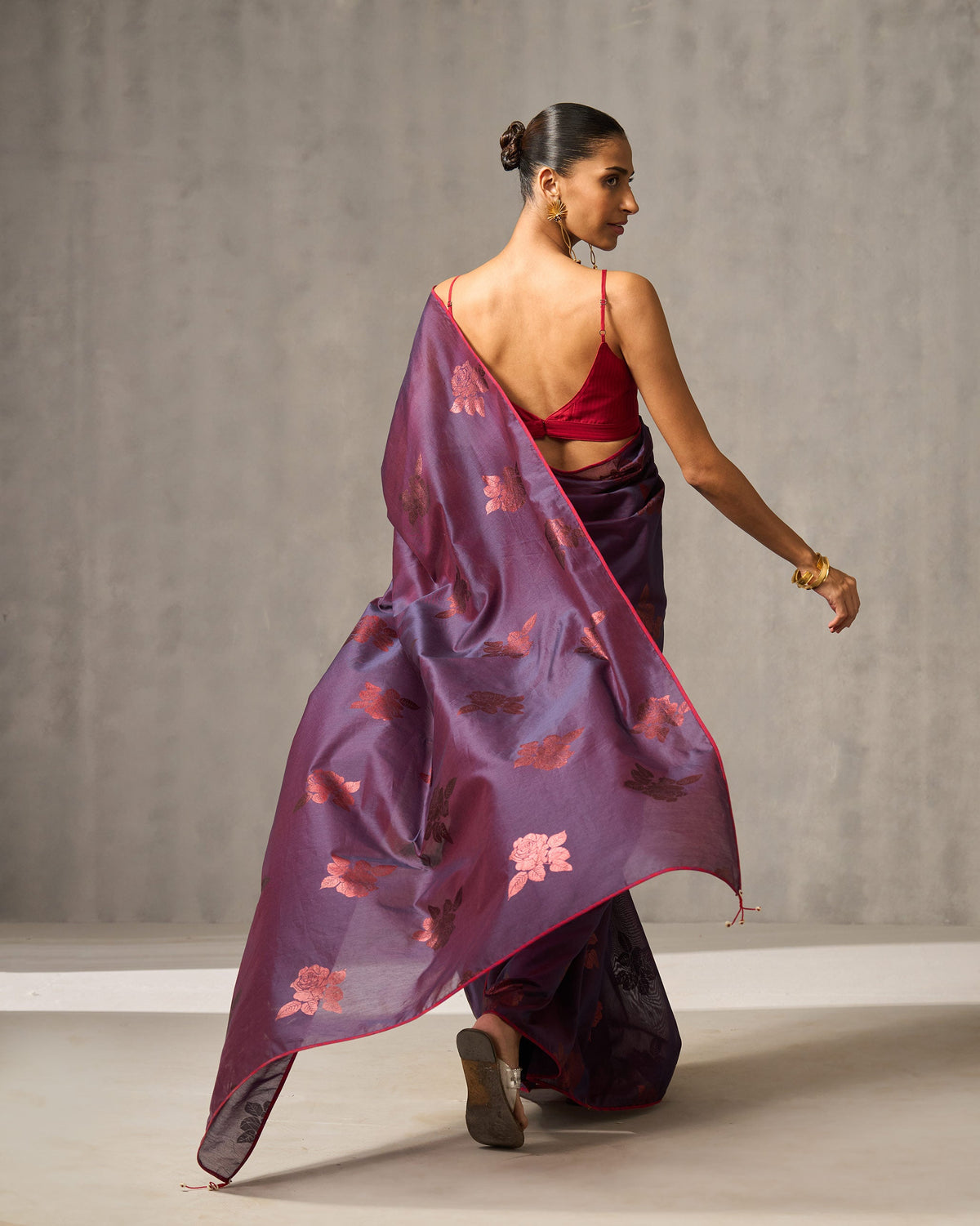 Back of Rose Rush Sari with a floral pallu, worn by a person.
