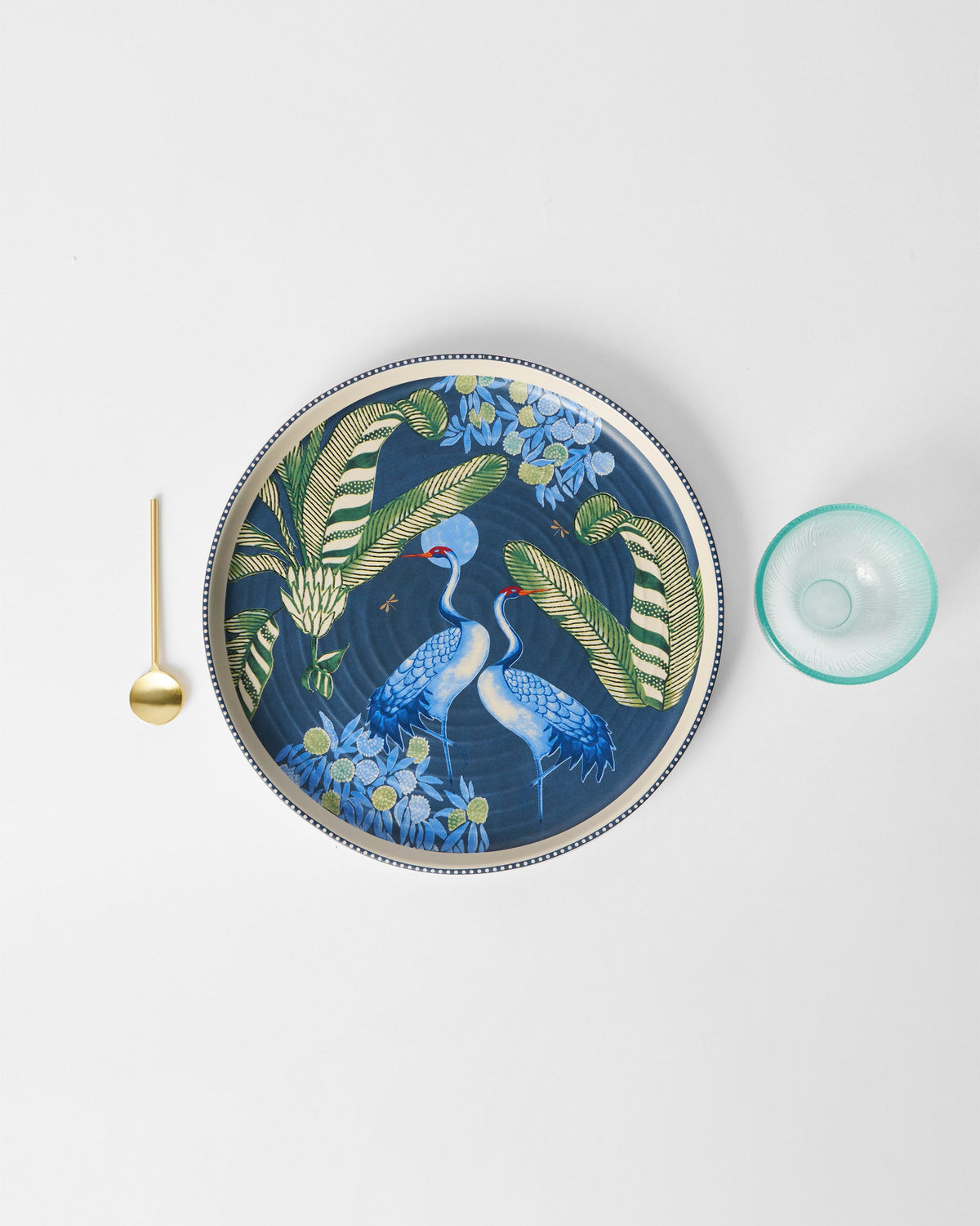 Overhead view of Dancing Crane Chip & Dip platter with a gold spoon at its left.