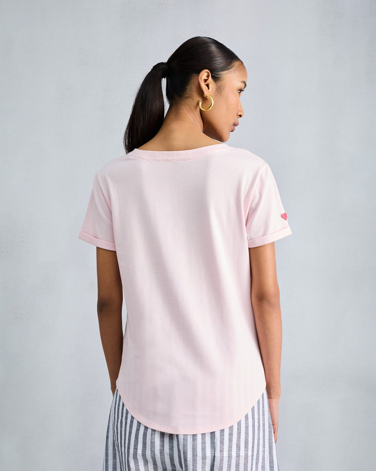 Back of the Basic T-Shirt in blush pink worn by a person.