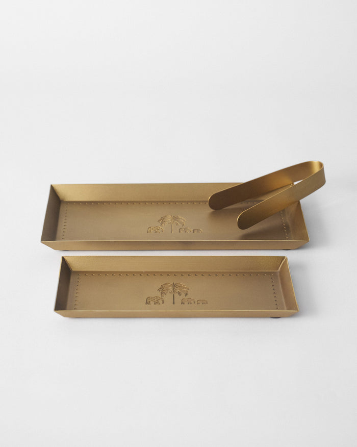 Aurum Platters with a tong, with embossed palm and elephant motifs.