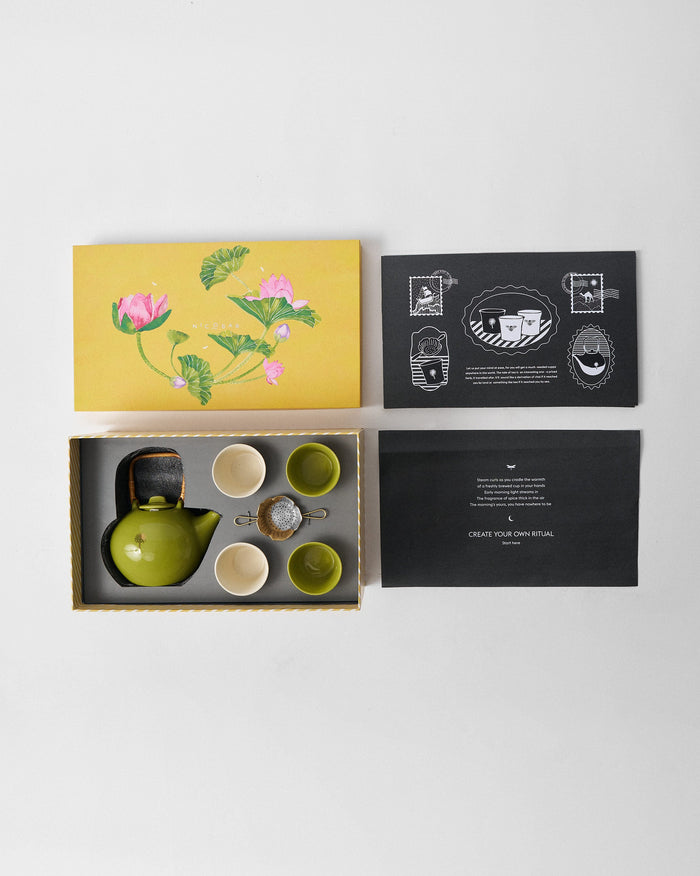 Float Tea Set packed beside a yellow gift box with a lotus illustration.