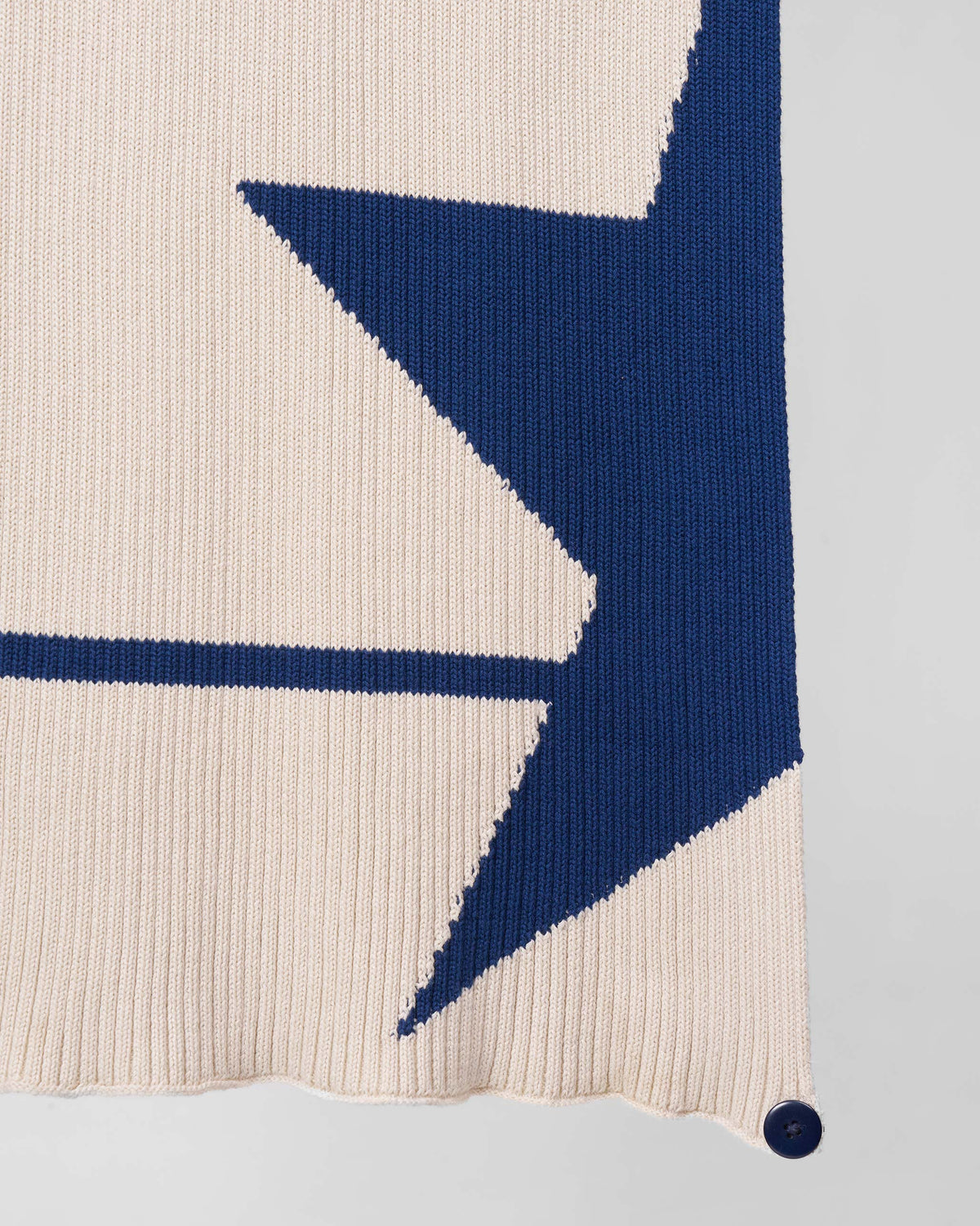Close-up of the Star Power Scarf's navy star point and corner button.