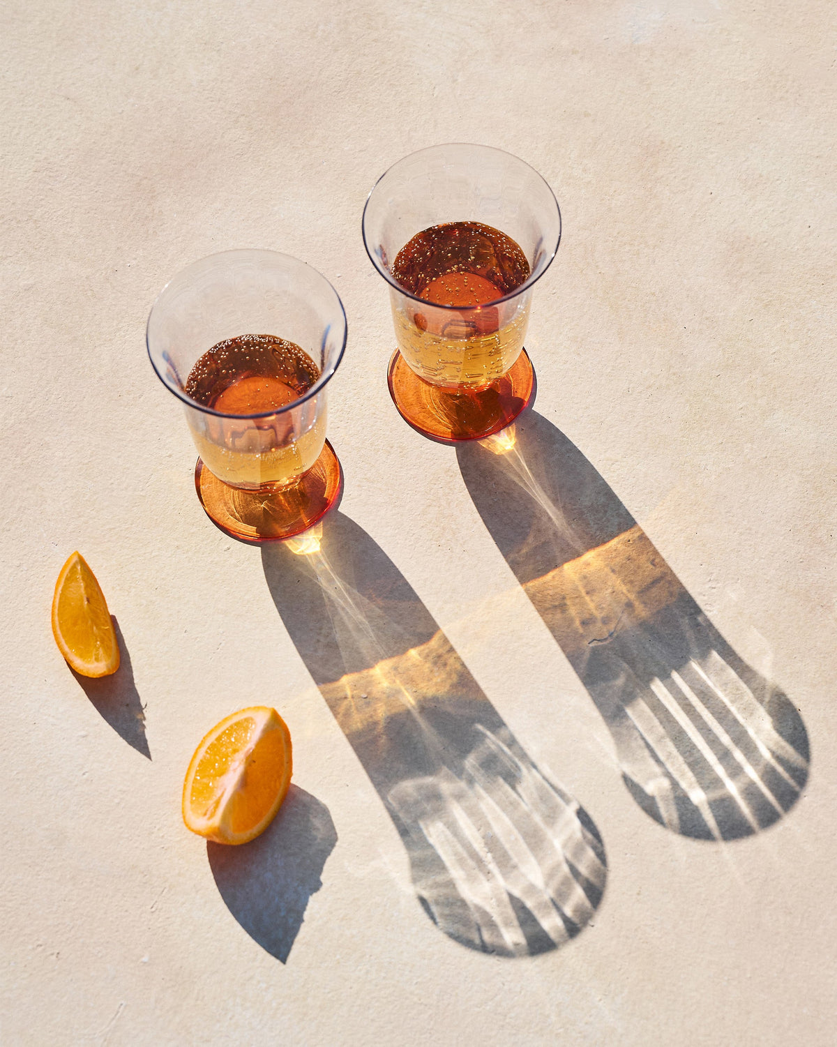 Overhead view of Oro cocktail glasses showing amber bases and flared rims.
