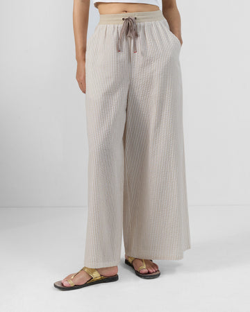 Brown and ivory striped Hera Pants with a flared leg and drawstring waist.