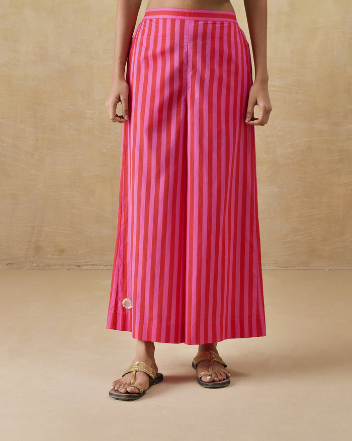 Person wearing red and berry striped Basic pyjamas with a wide A-line flare.