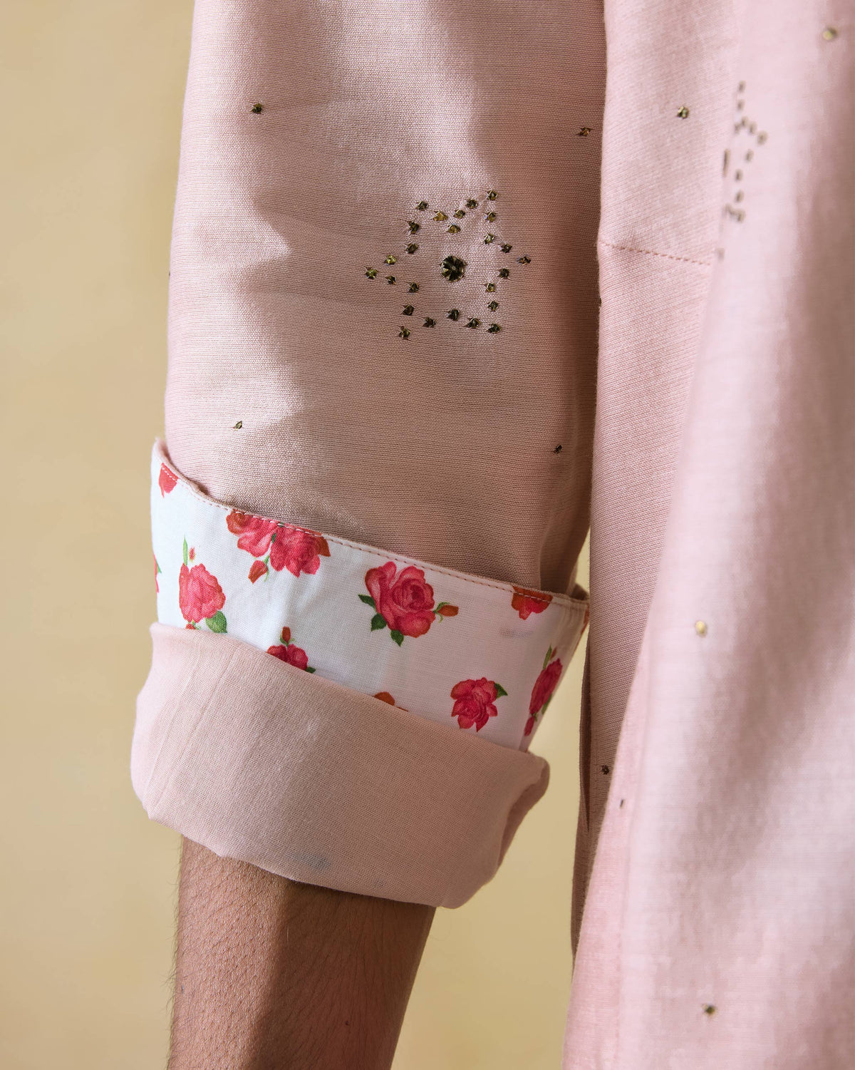 Close-up of a light pink Arham kurta sleeve with rose-print lining.