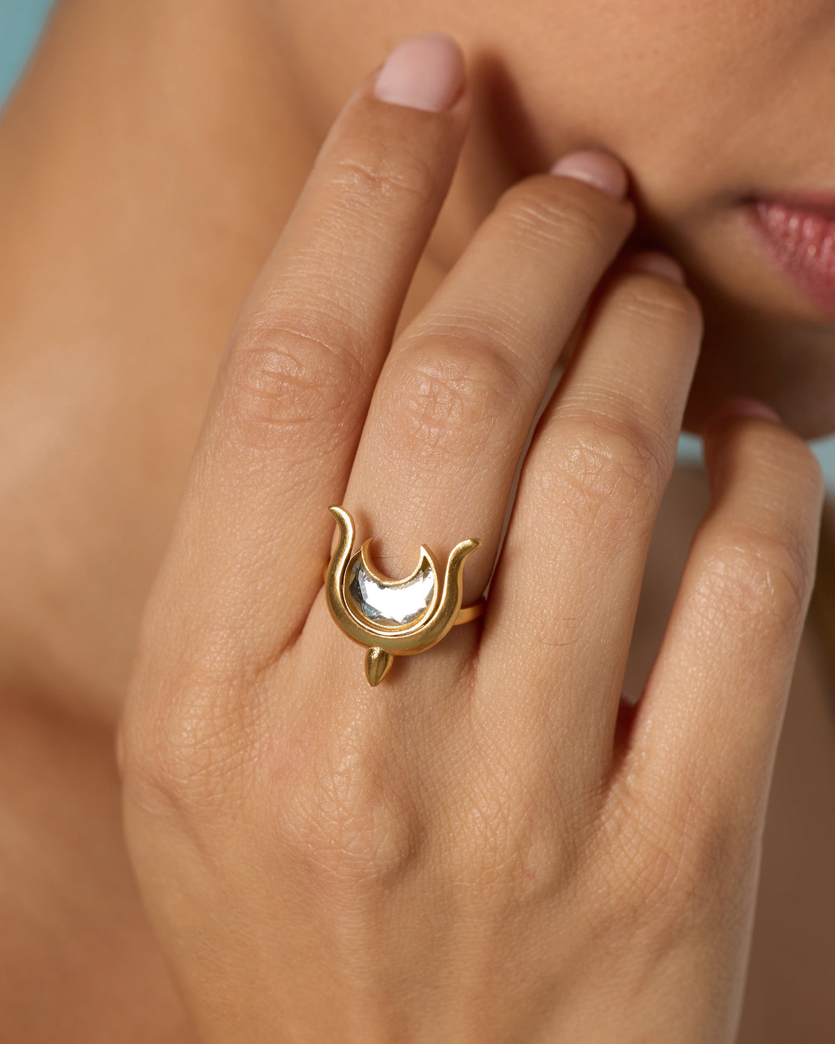 Close-up of the Chandphool ring on a finger, showing the crescent moon motif.