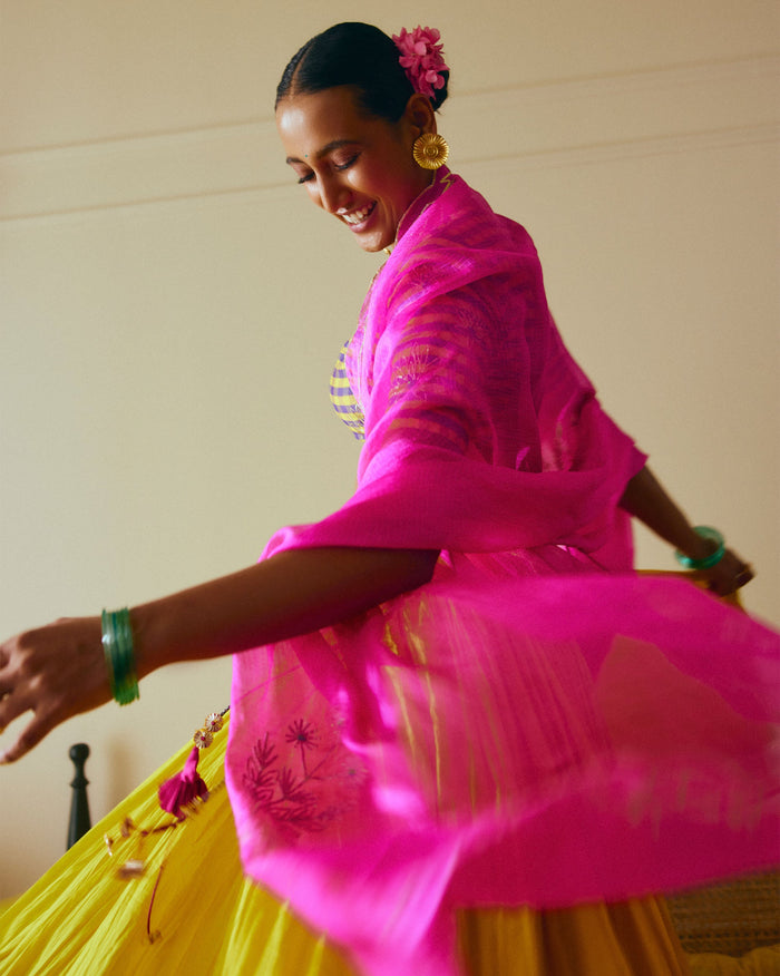 Person wearing a magenta Ishara dupatta draped over both arms.