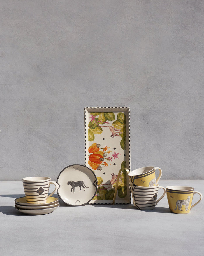 Chand Coffee Set with leopard mugs, cheetah plates, and a cashew cookie tray.