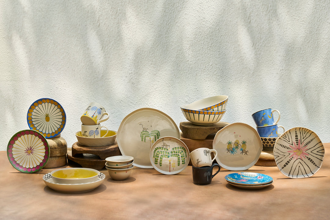 Blue Zebra Conical Mug among many ceramic pieces on a table.